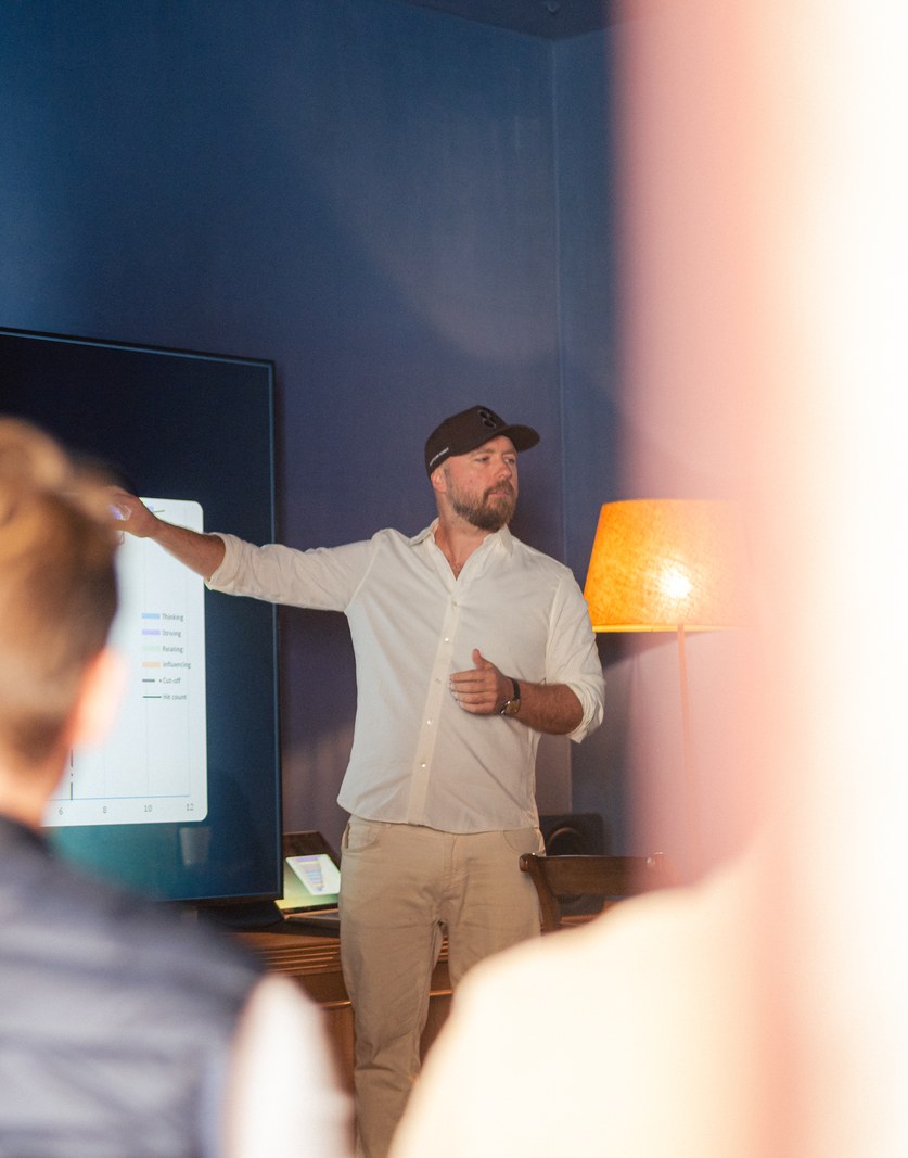 A speaker at a screen reading Talent and how to measure it, the room watching